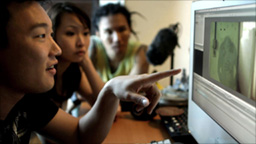 Film crew in
                    editing suite - Andrew, Sheena, Farid look at a
                    headless shadow